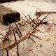 easter scene with crown of thorns, hammer and nails with blood on sand